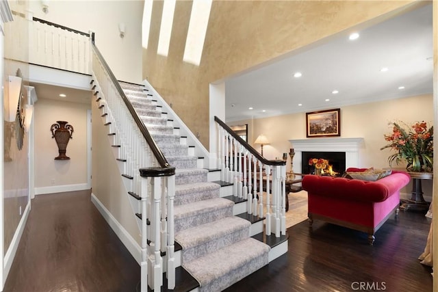 1921 Windward Ln, Newport Beach, CA 92660 - stairs with wood finished floors, a warm lit fireplace, recessed lighting, and a high ceiling