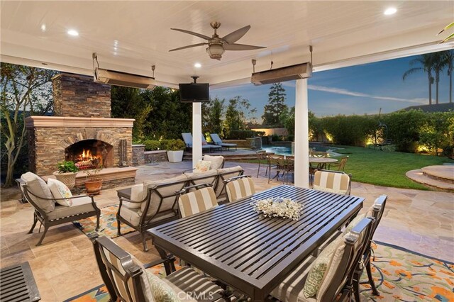 1921 Windward Ln, Newport Beach, CA 92660 - view of patio / terrace with an outdoor stone fireplace, outdoor dining space, and ceiling fan