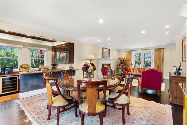 1921 Windward Ln, Newport Beach, CA 92660 - dining area featuring wine cooler, crown molding, recessed lighting, wood finished floors, and bar