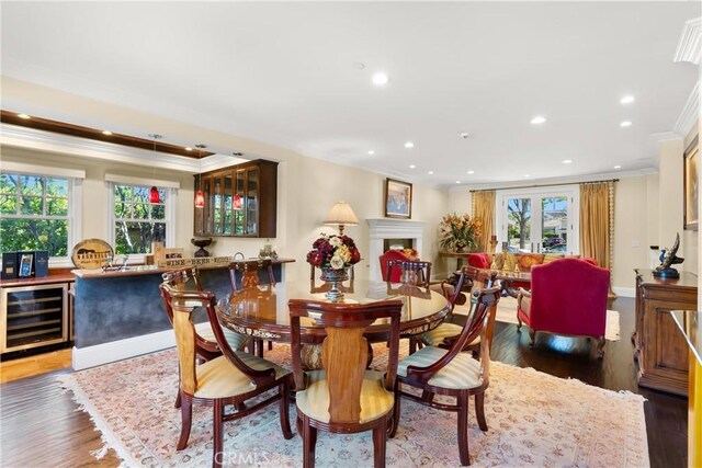 1921 Windward Ln, Newport Beach, CA 92660 - dining room featuring wine cooler, ornamental molding, recessed lighting, wood finished floors, and bar
