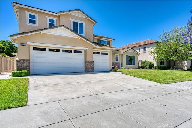 14939 Franklin Ln, Eastvale, CA 92880 - view of front of house with driveway, stucco siding, brick siding, and a garage