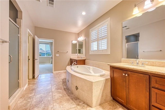 14939 Franklin Ln, Eastvale, CA 92880 - full bathroom featuring a shower stall, two vanities, a bath, and tile patterned flooring