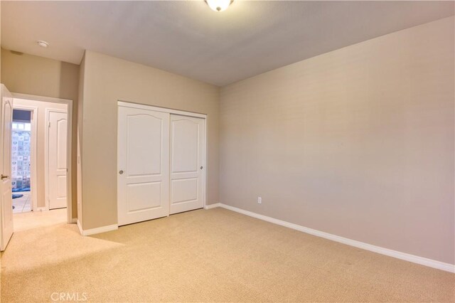 14939 Franklin Ln, Eastvale, CA 92880 - unfurnished bedroom with light colored carpet and a closet