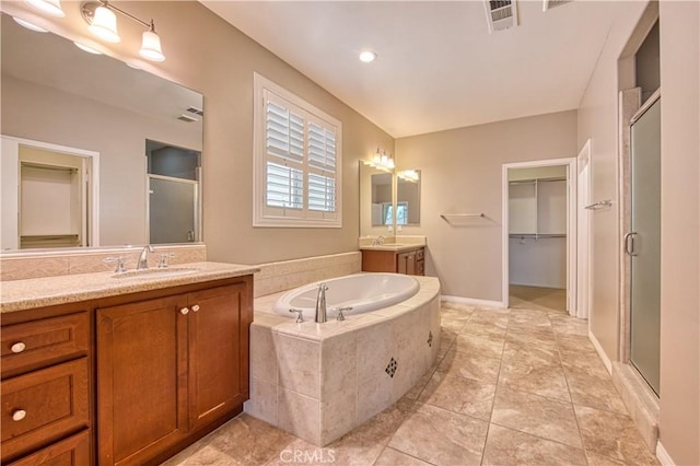 14939 Franklin Ln, Eastvale, CA 92880 - full bathroom with a stall shower, two vanities, a garden tub, and tile patterned flooring
