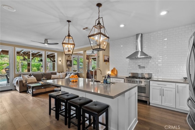 19969 Via Joyce Dr, Saugus, CA 91350 - kitchen featuring wall chimney exhaust hood, high end stove, open floor plan, dark wood-style flooring, and a sink