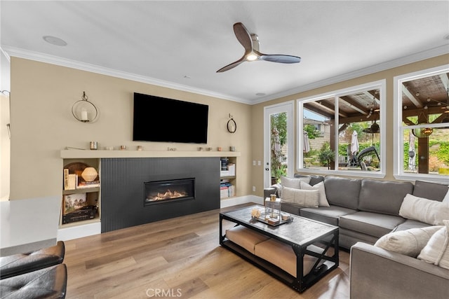 19969 Via Joyce Dr, Saugus, CA 91350 - living room featuring ornamental molding, wood finished floors, a ceiling fan, and a glass covered fireplace