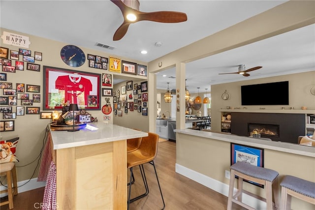 19969 Via Joyce Dr, Saugus, CA 91350 - indoor bar featuring ceiling fan, wood finished floors, dishwasher, a glass covered fireplace, and recessed lighting