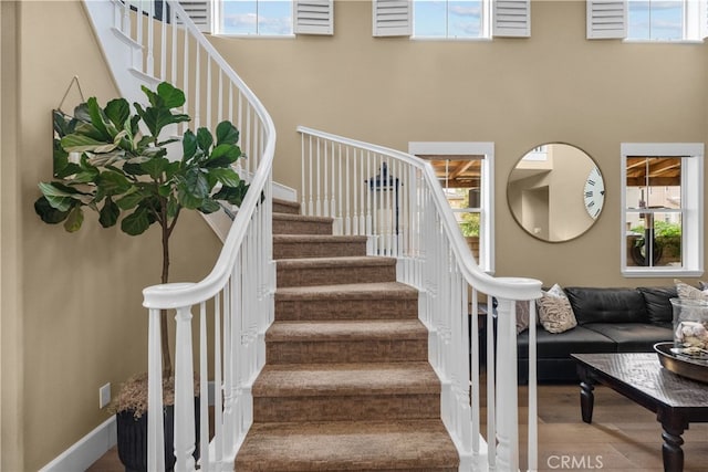 19969 Via Joyce Dr, Saugus, CA 91350 - stairs with baseboards, a towering ceiling, and wood finished floors