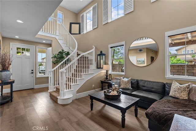 19969 Via Joyce Dr, Saugus, CA 91350 - living room featuring stairway, wood finished floors, baseboards, a towering ceiling, and recessed lighting