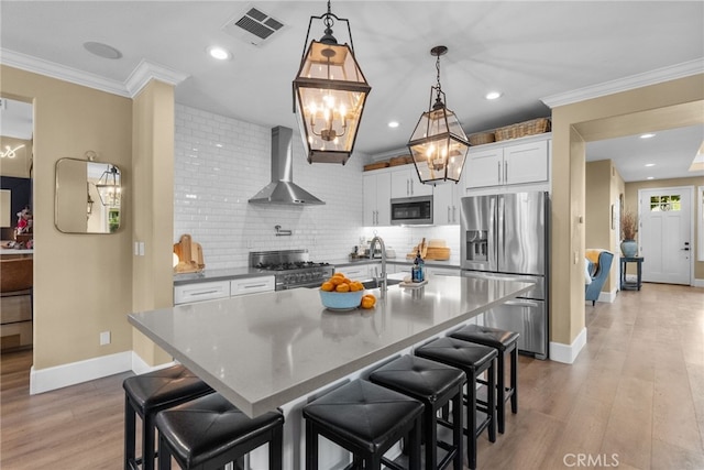19969 Via Joyce Dr, Saugus, CA 91350 - kitchen featuring wall chimney range hood, stainless steel appliances, baseboards, a chandelier, and tasteful backsplash
