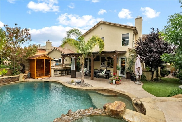 19969 Via Joyce Dr, Saugus, CA 91350 - rear view of property with a patio area, a chimney, stucco siding, and a pool with connected hot tub
