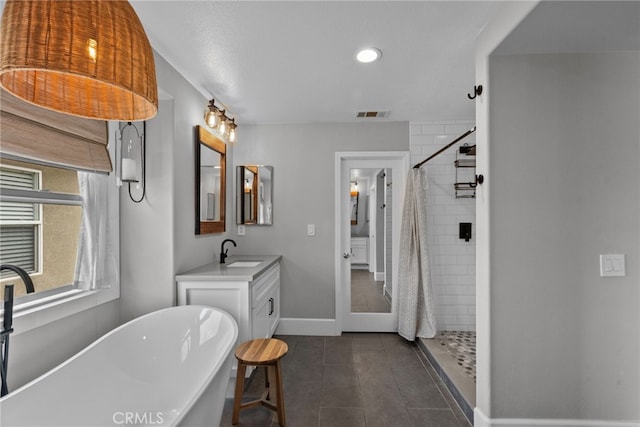19969 Via Joyce Dr, Saugus, CA 91350 - full bathroom with vanity, a tile shower, a freestanding bath, baseboards, and tile patterned floors