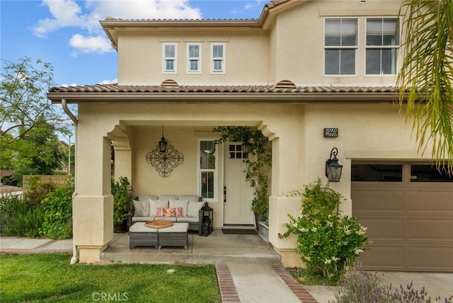 19969 Via Joyce Dr, Saugus, CA 91350 - property entrance with stucco siding, outdoor lounge area, and an attached garage