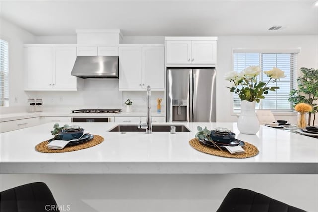 501 Embrook Way, West Covina, CA 91791 - kitchen with stainless steel refrigerator with ice dispenser, exhaust hood, light countertops, white cabinets, and a sink