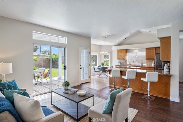 23906 Olson Ln, Lomita, CA 90717 - living room with a chandelier, dark wood finished floors, lofted ceiling, recessed lighting, and a textured ceiling