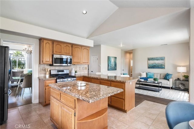 23906 Olson Ln, Lomita, CA 90717 - kitchen with stainless steel appliances, a center island, a peninsula, lofted ceiling, and open floor plan