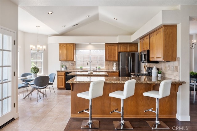 23906 Olson Ln, Lomita, CA 90717 - kitchen featuring appliances with stainless steel finishes, a peninsula, healthy amount of natural light, backsplash, and vaulted ceiling