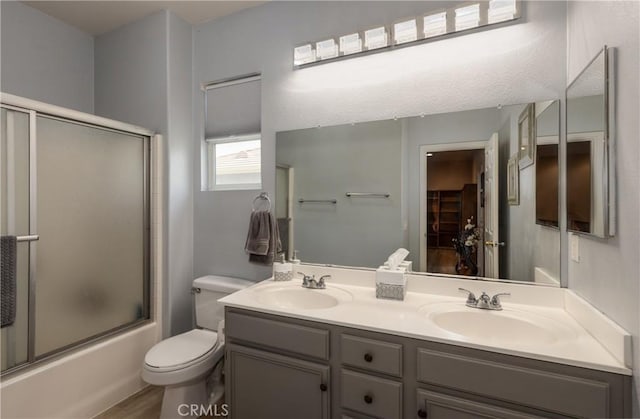 29207 Clear Spring Ln, Highland, CA 92346 - full bathroom with toilet, double vanity, combined bath / shower with glass door, and wood finished floors