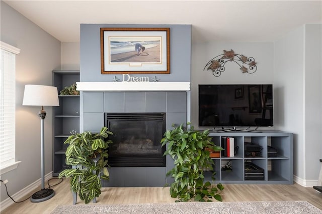 29207 Clear Spring Ln, Highland, CA 92346 - living area featuring wood finished floors, baseboards, and a tiled fireplace