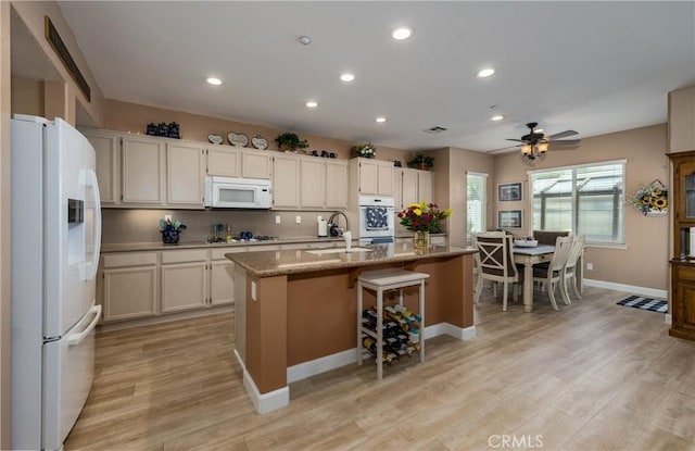 29207 Clear Spring Ln, Highland, CA 92346 - kitchen featuring white appliances, a sink, recessed lighting, a center island with sink, and light wood-type flooring
