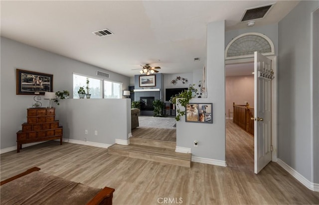 29207 Clear Spring Ln, Highland, CA 92346 - living area featuring wood finished floors, baseboards, ceiling fan, and a glass covered fireplace