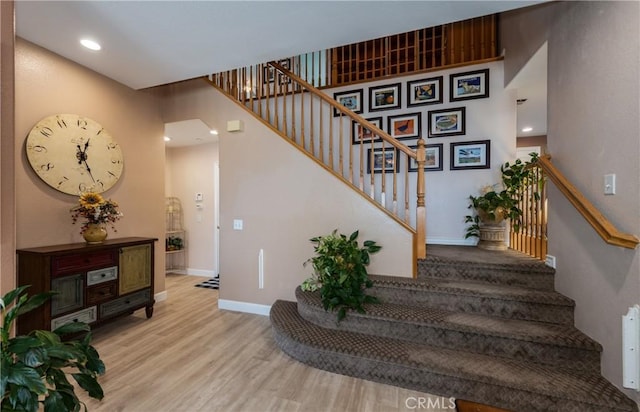 29207 Clear Spring Ln, Highland, CA 92346 - stairs with wood finished floors, baseboards, and recessed lighting