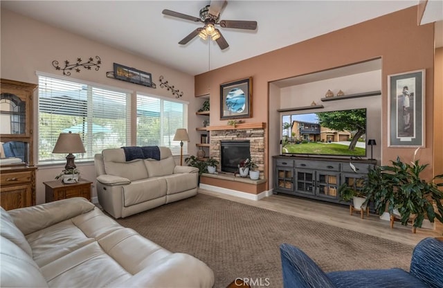 29207 Clear Spring Ln, Highland, CA 92346 - living area featuring wood finished floors, ceiling fan, and a stone fireplace