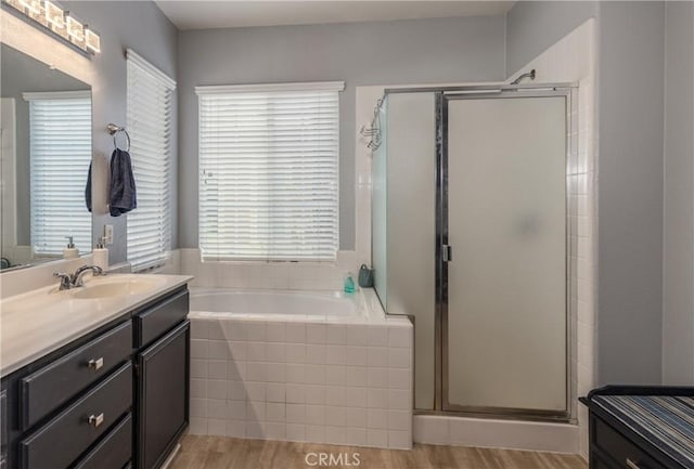 29207 Clear Spring Ln, Highland, CA 92346 - bathroom with vanity, healthy amount of natural light, a garden tub, and a stall shower