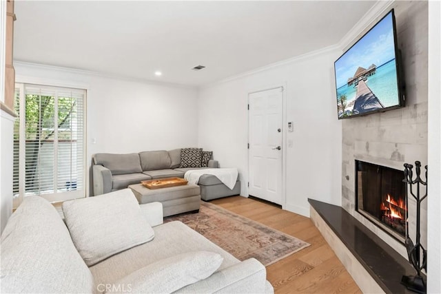 2013 Speyer Ln Unit A, Redondo Beach, CA 90278 - living area with light wood finished floors, ornamental molding, a tile fireplace, and recessed lighting