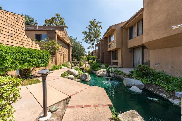 1675 W Lambert Rd Unit G, La Habra, CA 90631 - view of community with a garden pond and a patio area