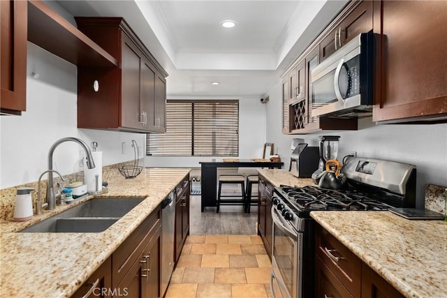 1675 W Lambert Rd Unit G, La Habra, CA 90631 - kitchen featuring appliances with stainless steel finishes, a sink, a tray ceiling, recessed lighting, and light stone countertops