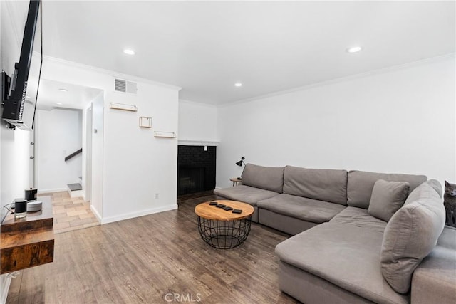 1675 W Lambert Rd Unit G, La Habra, CA 90631 - living area with wood finished floors, crown molding, stairs, recessed lighting, and a fireplace