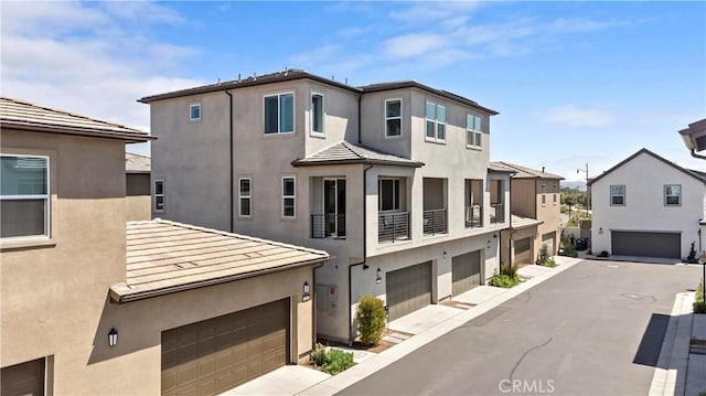 297 Lynx, Irvine, CA 92618 - view of front of home featuring stucco siding, a garage, and a residential view