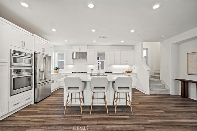 297 Lynx, Irvine, CA 92618 - kitchen featuring stainless steel appliances, under cabinet range hood, light countertops, a breakfast bar area, and recessed lighting