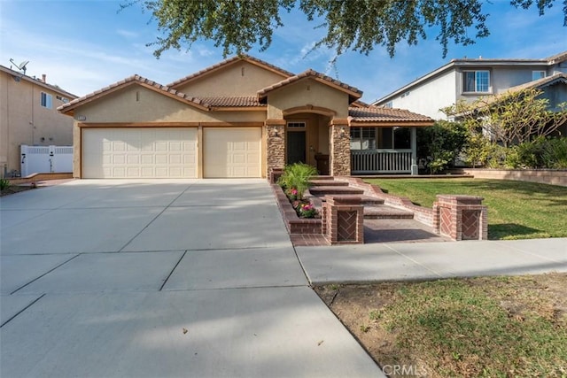 960 Hemingway Dr, Corona, CA 92878 - mediterranean / spanish house with stucco siding, a garage, a tile roof, driveway, and stone siding