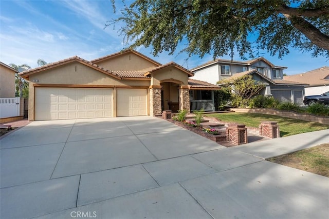 960 Hemingway Dr, Corona, CA 92878 - mediterranean / spanish house featuring concrete driveway, stucco siding, an attached garage, stone siding, and a tile roof