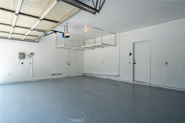 960 Hemingway Dr, Corona, CA 92878 - garage featuring a garage door opener and baseboards