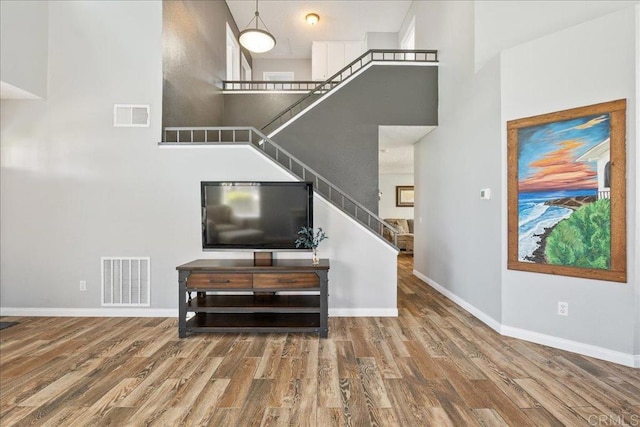 655 Boysenberry Way, Oceanside, CA 92057 - living room featuring wood finished floors, a high ceiling, stairs, and baseboards