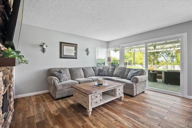 655 Boysenberry Way, Oceanside, CA 92057 - living room featuring wood finished floors, a textured ceiling, and baseboards