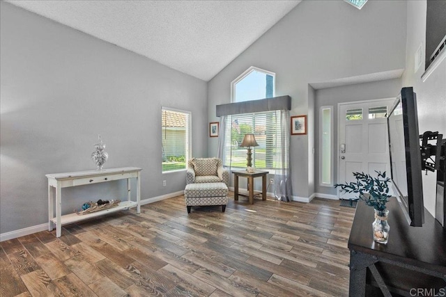 655 Boysenberry Way, Oceanside, CA 92057 - sitting room featuring high vaulted ceiling, wood finished floors, plenty of natural light, baseboards, and a textured ceiling