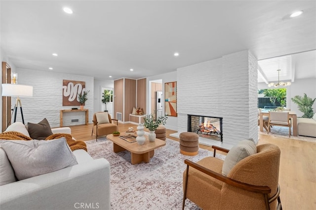 3830 Cedar Ave, Long Beach, CA 90807 - living area with light wood-style flooring, recessed lighting, a multi sided fireplace, and a chandelier
