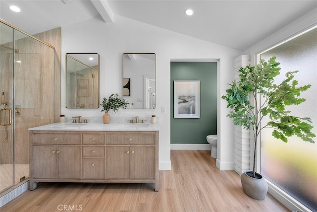 3830 Cedar Ave, Long Beach, CA 90807 - bathroom featuring toilet, wood finished floors, double vanity, a stall shower, and baseboards