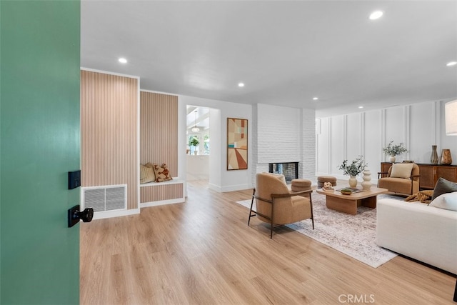 3830 Cedar Ave, Long Beach, CA 90807 - living area with wood finished floors, a brick fireplace, recessed lighting, and baseboards