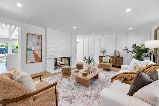 3830 Cedar Ave, Long Beach, CA 90807 - living area with light wood-style floors, recessed lighting, a fireplace, and a decorative wall