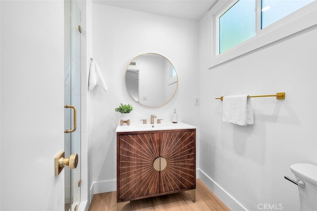 3830 Cedar Ave, Long Beach, CA 90807 - full bathroom with baseboards, vanity, wood finished floors, and toilet