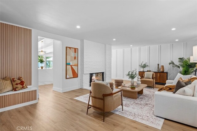 3830 Cedar Ave, Long Beach, CA 90807 - living area with light wood finished floors, a brick fireplace, recessed lighting, and baseboards