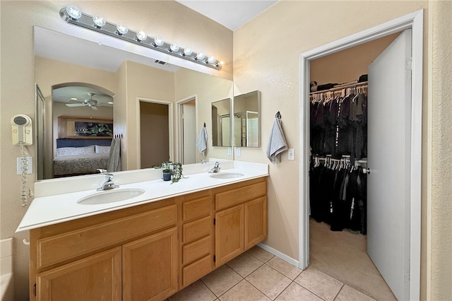32839 Charmes Ct, Temecula, CA 92592 - ensuite bathroom featuring double vanity, tile patterned floors, ceiling fan, and a walk in closet