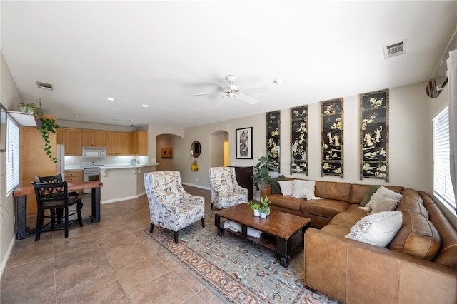 32839 Charmes Ct, Temecula, CA 92592 - living room featuring arched walkways, ceiling fan, baseboards, light tile patterned floors, and recessed lighting