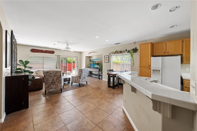 32839 Charmes Ct, Temecula, CA 92592 - kitchen featuring white refrigerator with ice dispenser, tile countertops, plenty of natural light, recessed lighting, and ceiling fan
