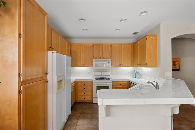 32839 Charmes Ct, Temecula, CA 92592 - kitchen with white appliances, a sink, a peninsula, tile patterned floors, and arched walkways
